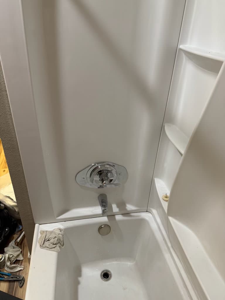 After: close-up of new tub and shower valve trim, clean finish — Oopsie Daisy Plumbing Northern Colorado plumbing