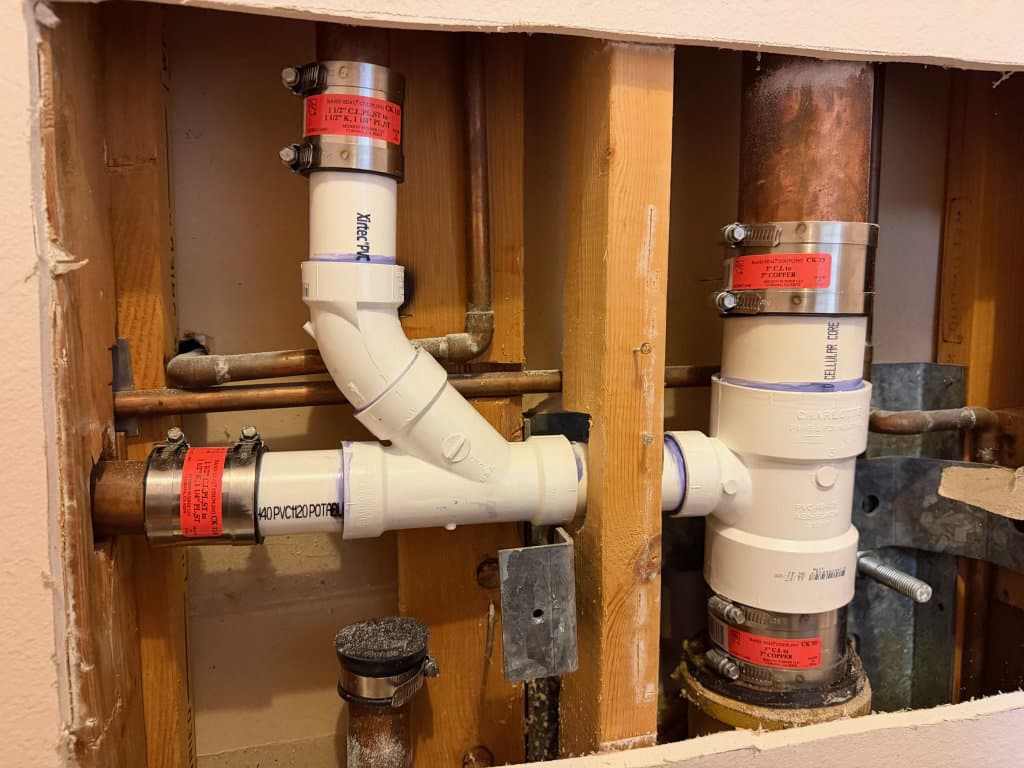 During: new PVC drain pipes and cast-iron to PVC transition with band-seal couplings — Oopsie Daisy Plumbing drain repair Northern Colorado